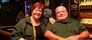 Donna and Jim White, owners of Sam's Place Tavern stand together next to their cigar humidor